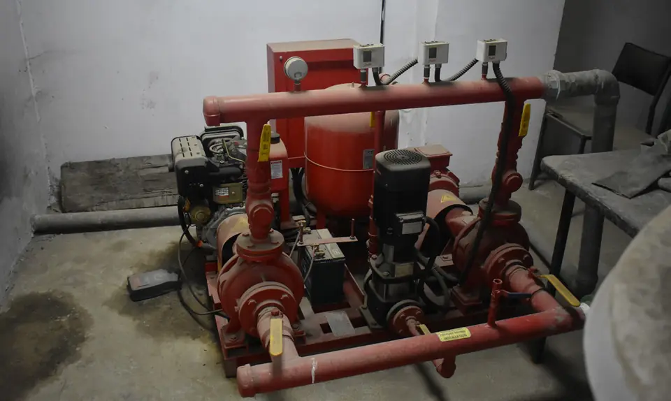 Red fire pump set with pipework in the pump room